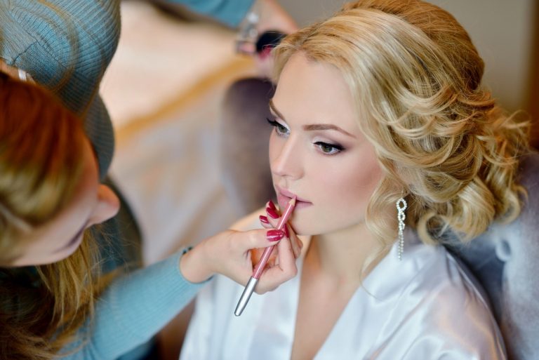 Wedding makeup artist making a make up for bride